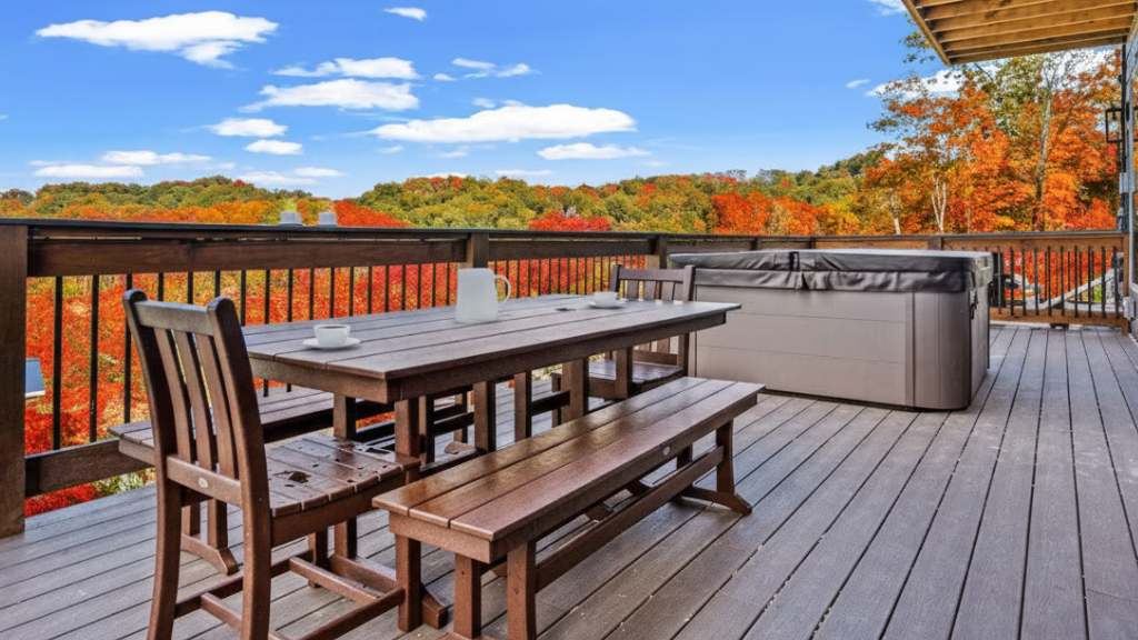 Wooden Porch Terrace overlooking a stunning Lush Autumn Landscape in the Smoky Mountains. Features an outdoor table for dining or coffee with a sunny sky view, East TN.
