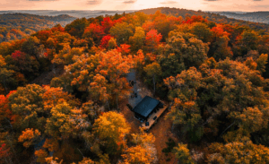 Custom-Made Luxury Cabin seen from above, surrounded by lush autumn foliage in the Smoky Mountains, East TN.