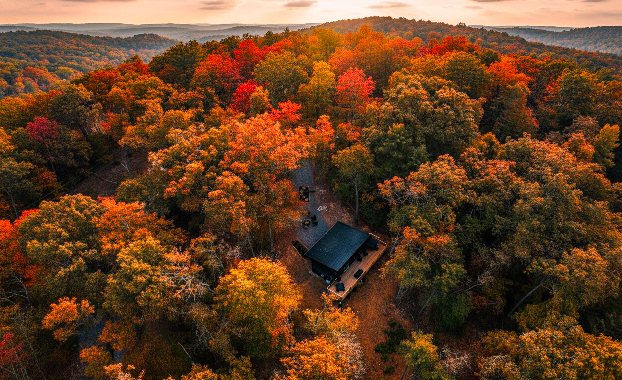 Custom-Made Luxury Cabin seen from above, surrounded by lush autumn foliage in the Smoky Mountains, East TN.