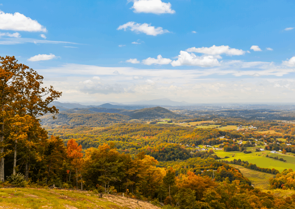 Stunning Peak Autumn Landscape view of the Smoky Mountains. Vibrant fall colors seen from a luxury cabin deck in East TN.