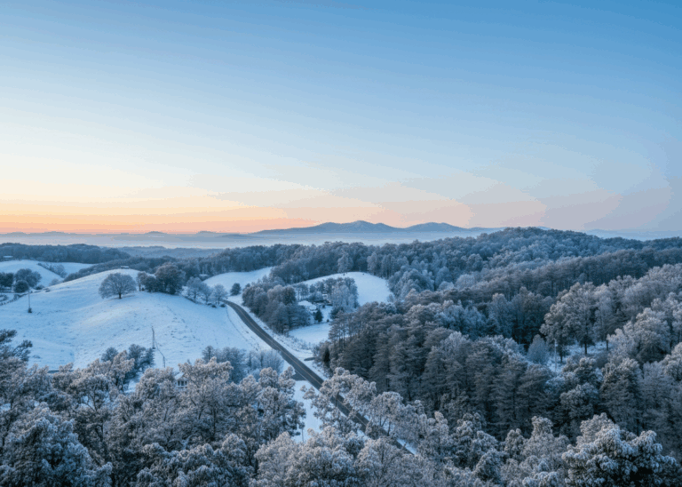 Image shows an amazing winter landscape of the Smoky Mountain Region, filled with snow on a beautiful winter sunset. High-yield rental property setting.