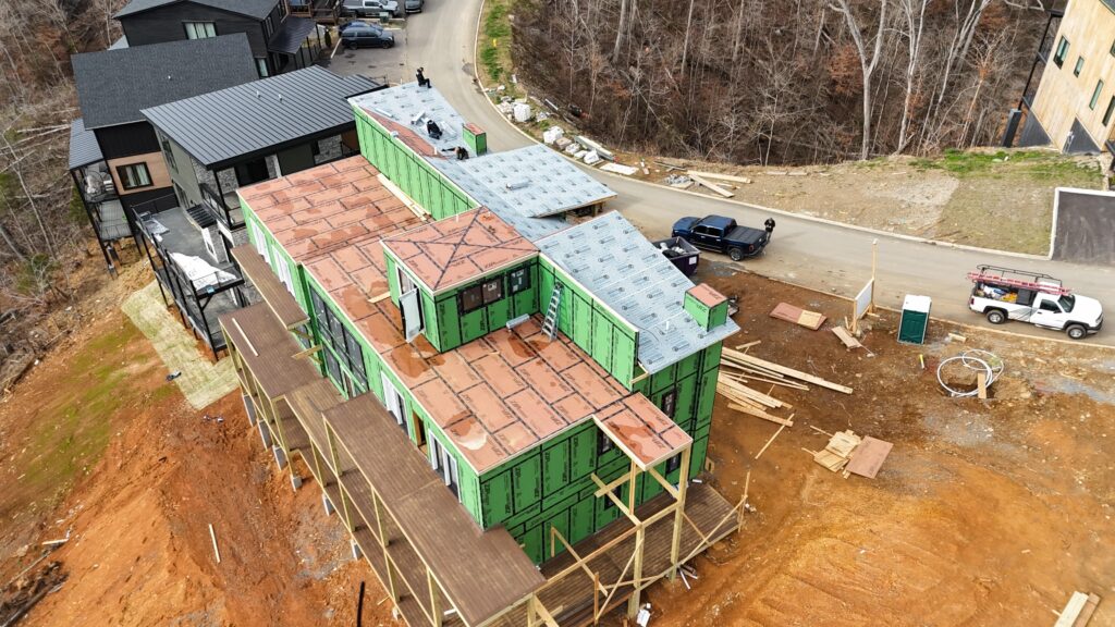 Advanced ground-up construction process on steep mountain terrain by MCHB. Showcasing the impressive structural build-up of a luxury cabin in East Tennessee.
