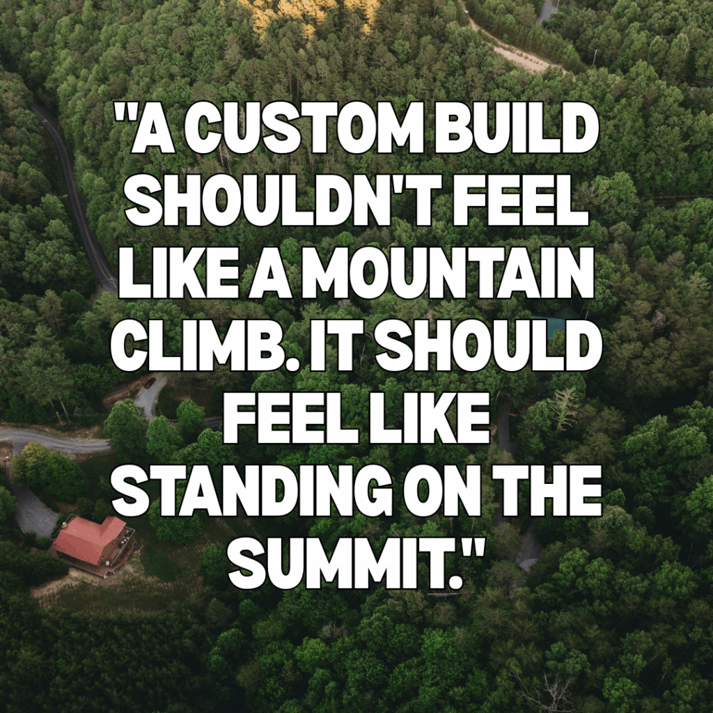 Aerial view of a lush Smoky Mountain forest and custom cabin roof. Overlay quote reads: "a custom build shouldn't feel like a mountain climb, it should feel like standing on the summit," highlighting the seamless MCHB turnkey process.