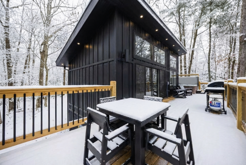 Luxury mini-cabin snowy terrace with a custom wooden deck and exterior wood finishes. A winter-ready design by MCHB in the Smoky Mountains, Sevierville, TN.