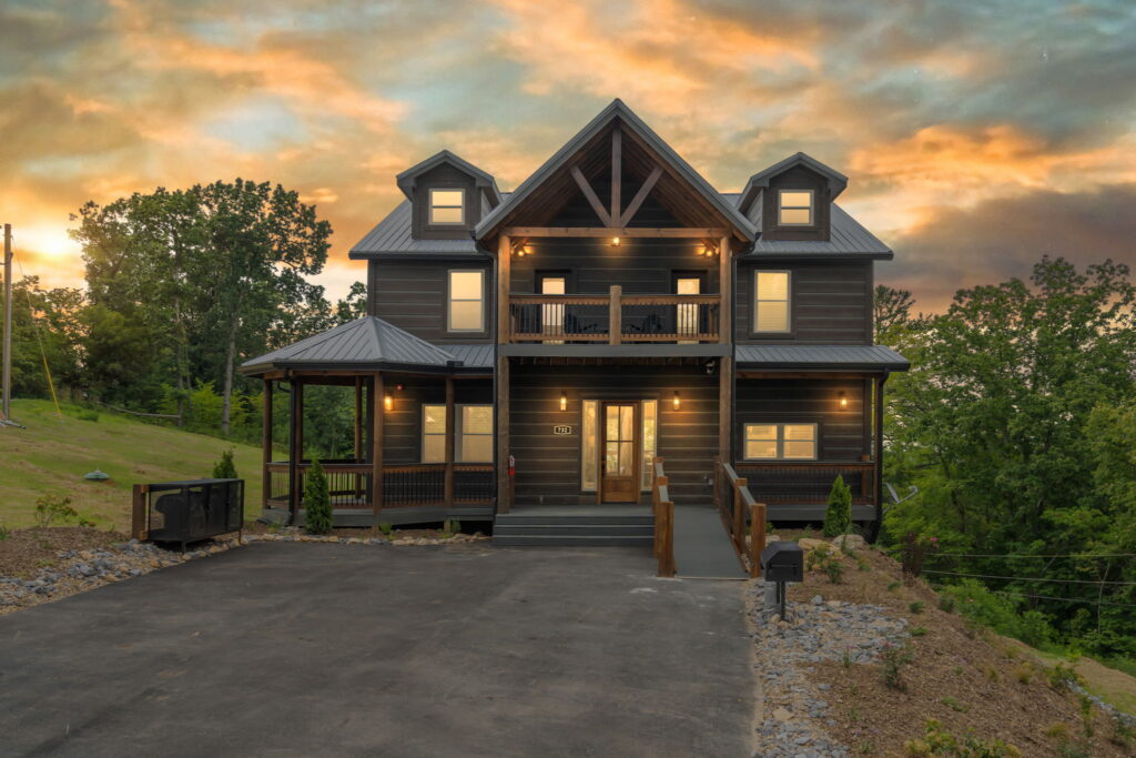 Exterior of Shell Mountain Sunrise, a 4,800 sq. ft. luxury mountain cabin built by MCHB. Features 3 levels of decking and expansive windows for group rentals in the Smoky Mountains.