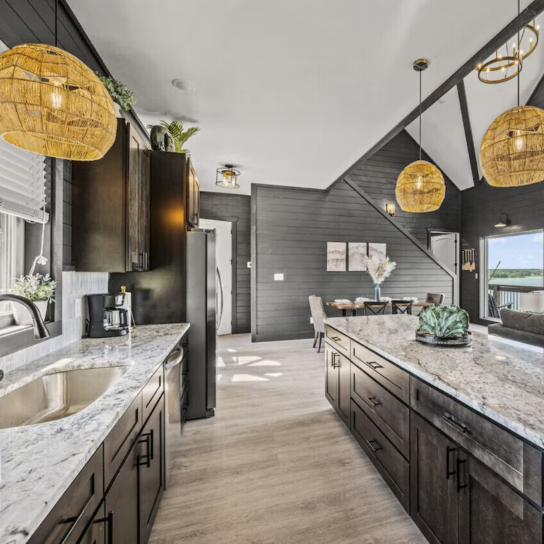 Finished open-concept living area in an MCHB luxury cabin. Minimalist interior design with modern aesthetics, neutral color palette, and expansive windows in the Smoky Mountains.