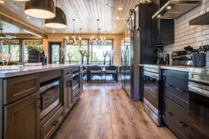 Leading line artistic view of a luxury MCHB mountain kitchen in Sevierville, TN, showing high-end appliances and the dining area.