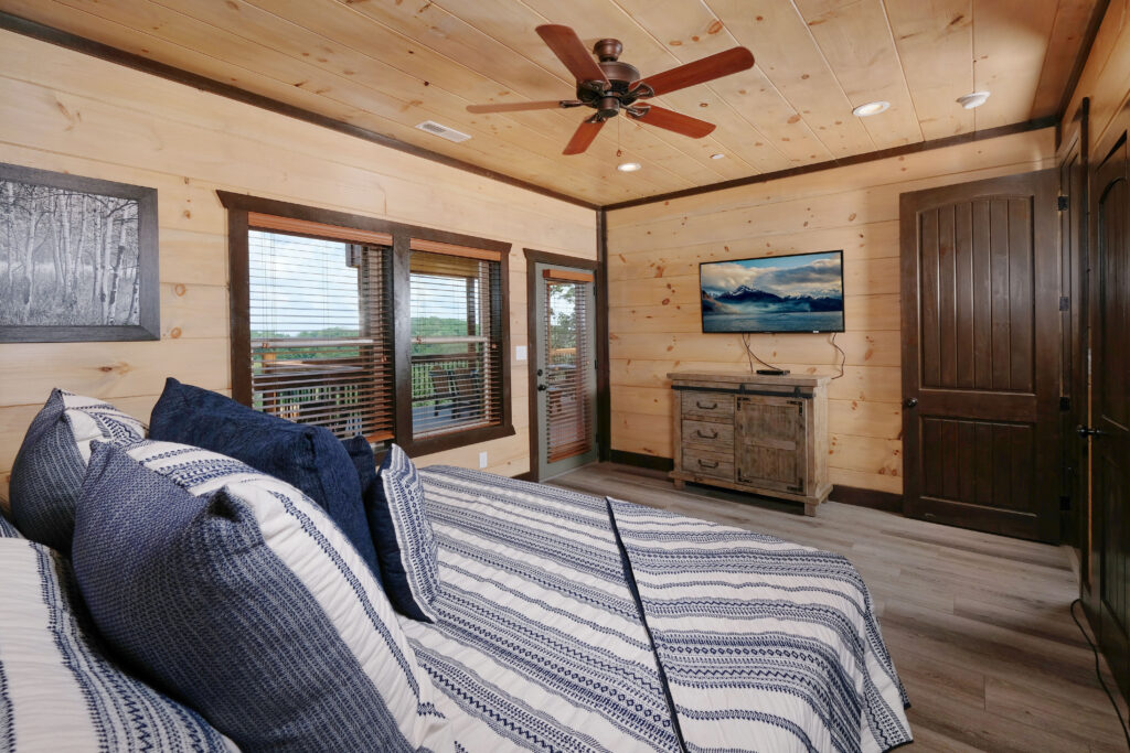 Luxury classic-contemporary cabin bedroom by MCHB in Pigeon Forge, TN. Features rich full-wood finishes, custom furniture, and integrated modern smart-home technology.