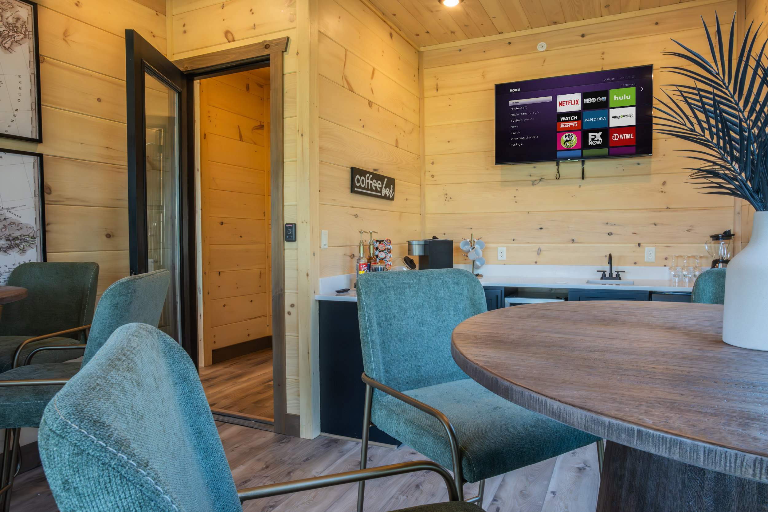 Custom beverage station and wine bar in a Sevierville MCHB luxury cabin. Features rustic stone accents, a built-in wine cooler, and designer glassware storage.