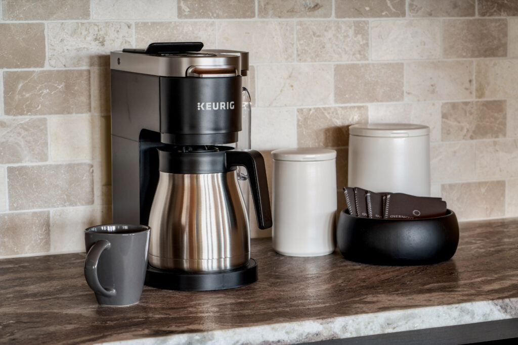 Modern coffee machine on a custom MCHB marble countertop in Gatlinburg, TN. Features high-end appliances, detailed marble veining, and luxury cabin kitchen finishes.