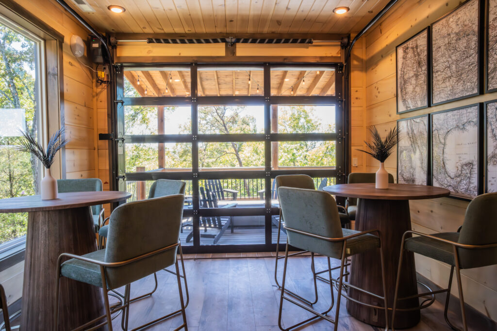 Intimate MCHB breakfast nook and coffee area in Pigeon Forge, TN. Features floor-to-ceiling windows with panoramic Smoky Mountain views and custom-made seating.