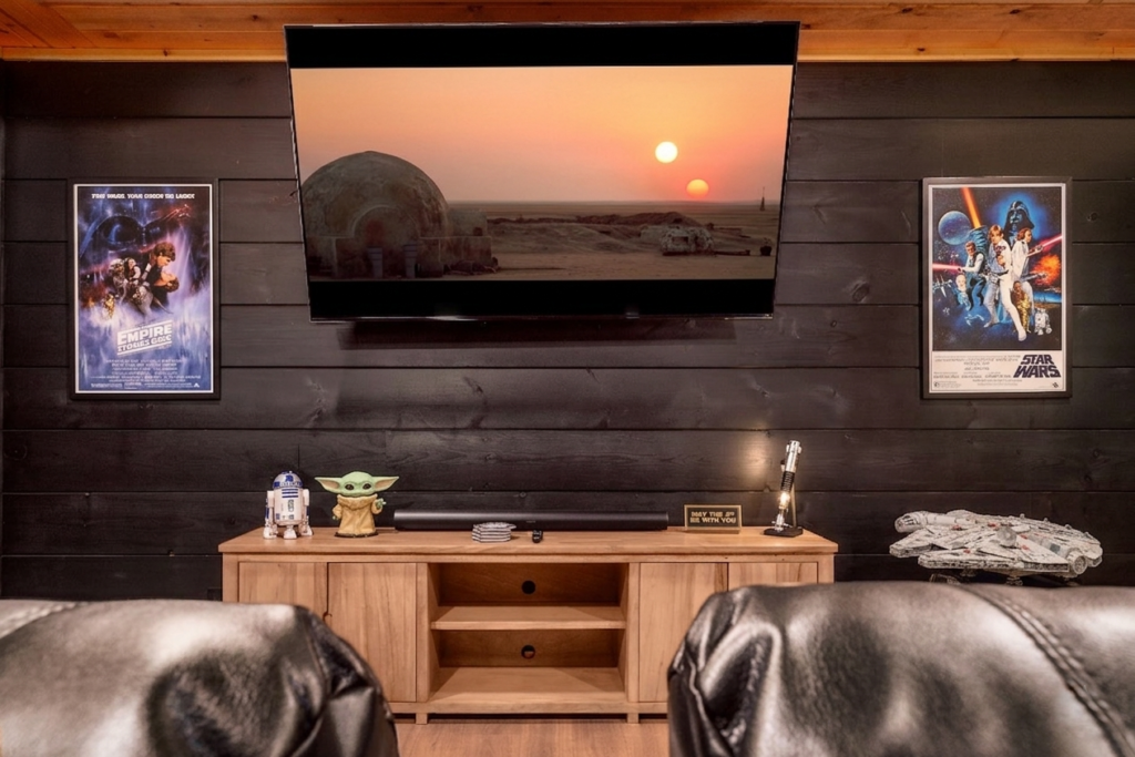 Close-up of a cinematic home theater in a luxury Smoky Mountain cabin, highlighting ambient lighting and high-end theater seating.