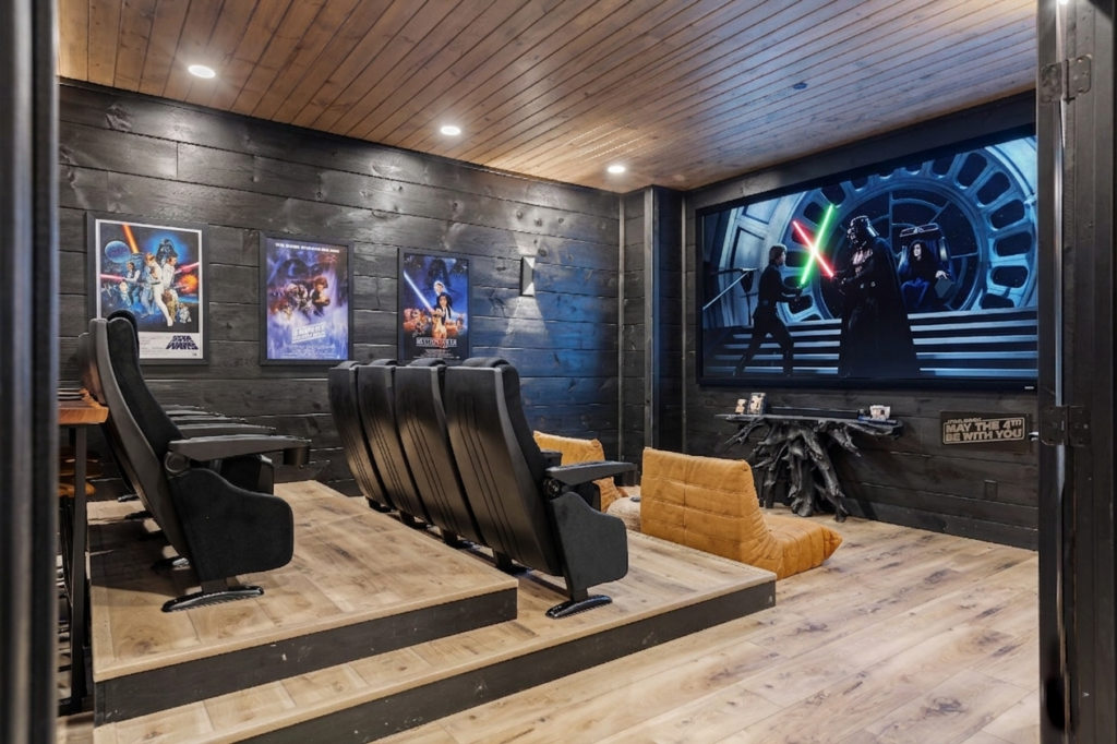 Close-up of a cinematic home theater in a luxury Smoky Mountain cabin, highlighting ambient lighting and high-end theater seating.