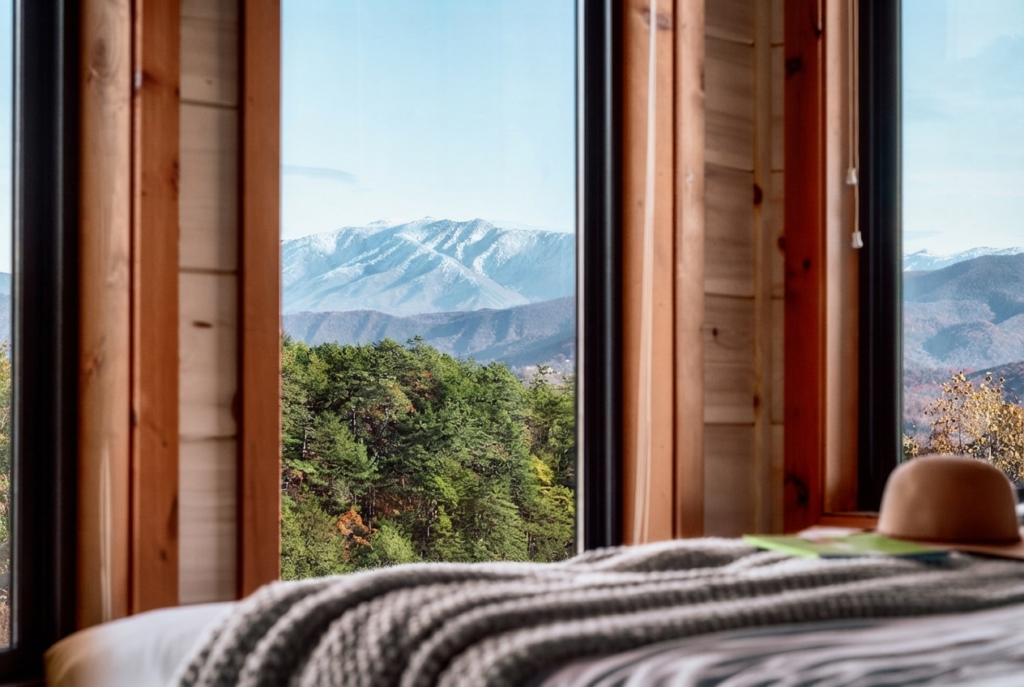 Detailed shot of a luxury cabin master bedroom suite designed by MCHB, showcasing premium tongue-and-groove accent walls, custom lighting, and high-end textiles.