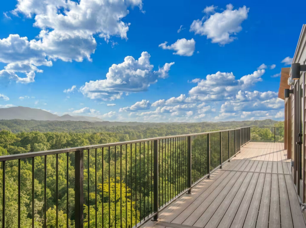 View from a wide custom rooftop deck by MCHB overlooking an incredible, wide-spanning view of the Smoky Mountain range during a clear summer afternoon.