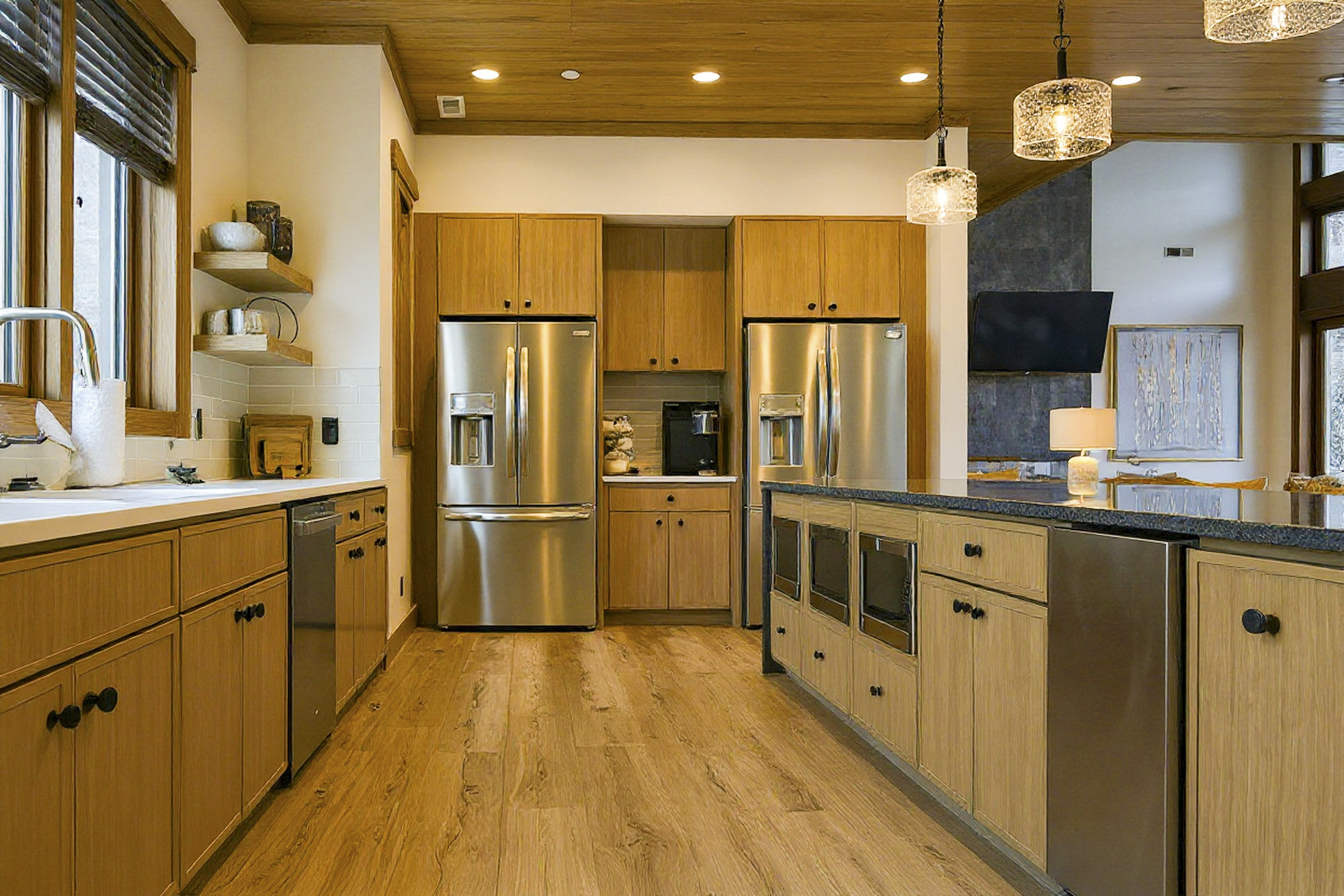 Wide-angle view of the luxury chef kitchen inside Celeste Estate featuring custom cabinetry, marble counters, and designer lighting built by Mountain Cabin Home Builders